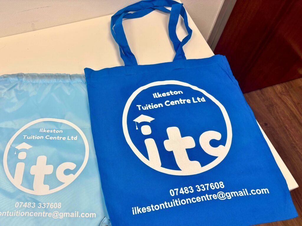 Two Ilkeston Tuition Centre branded bags - one is light blue and one is dark blue.