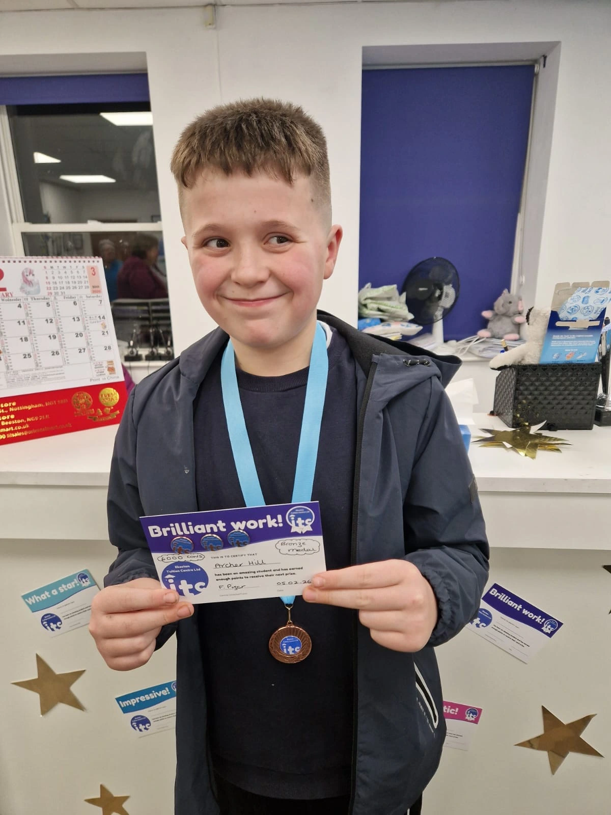 Archer holding his medal