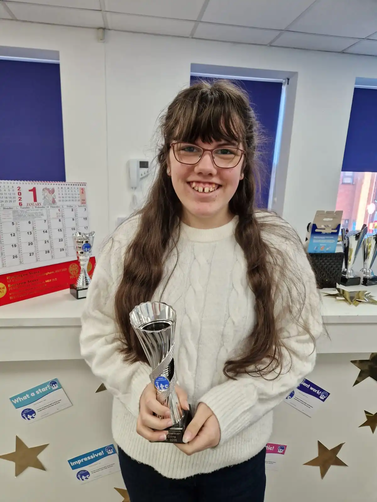 Genevieve holding her award